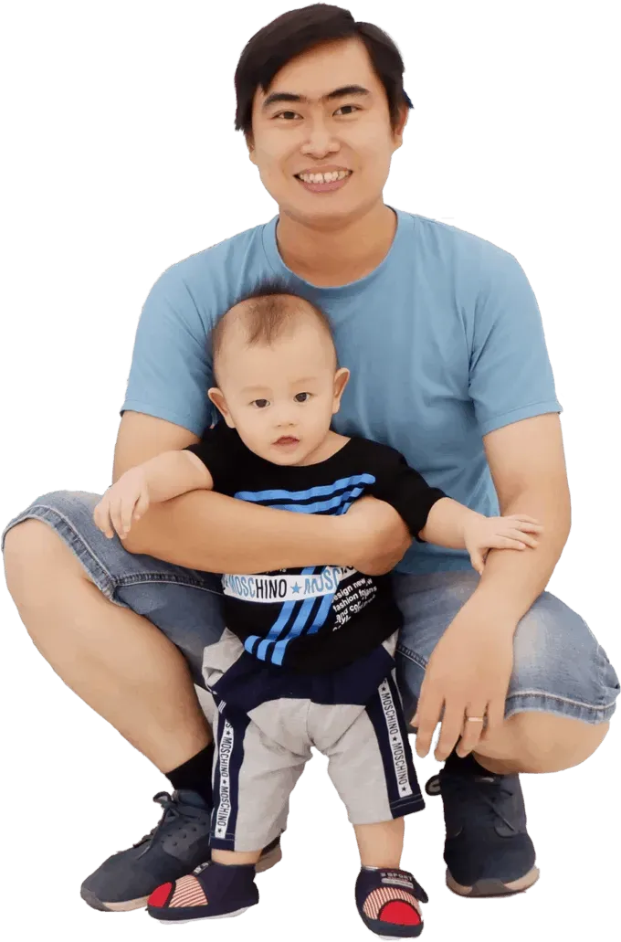 Cường Thạch sitting with his young child